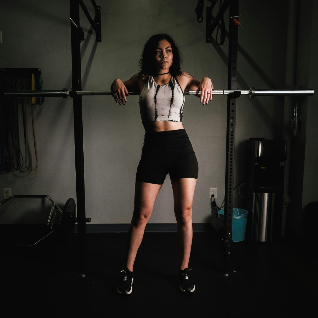 Woman lifting a barbell in a gym setting